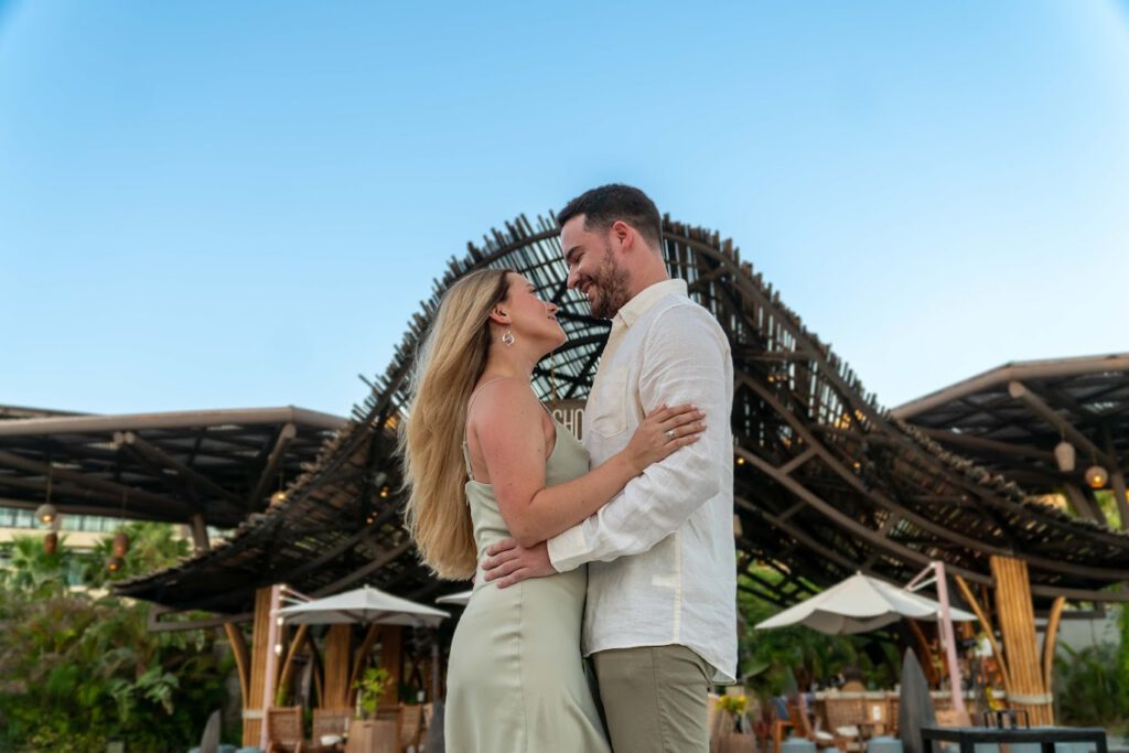 Couple photo session in Los Cabos at a luxury resort with a romantic couple smiling and embracing.